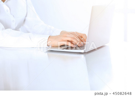Close-up of business woman hands typing on laptop computer. Secretary at work in office 45082648