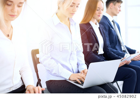 Group of business people sitting in office waiting for job interview, close-up. Hands of woman 45082902