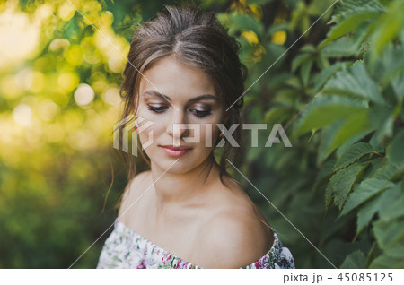 The pregnant girl has rest sitting bench with ivy 45085125