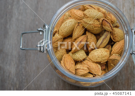 Close up of Almond seeds in the glass jar  45087141