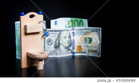 Wooden toy toilet and money on black 45090890