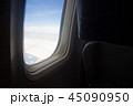 Plane in window view with the seat traveling  45090950
