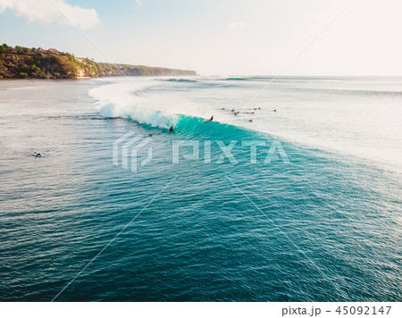 Aerial view with surfers and turquoise barrel wave Aerial view with surfers and turquoise barrel wave 45092147