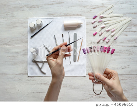 Nail art samples in female hands. Top view. Nail art samples in female hands. Top view. 45096610