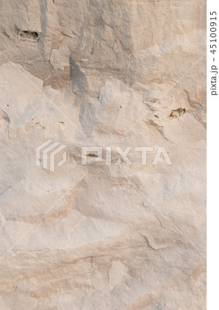 Closeup limestone rock face with weathered strata 45100915