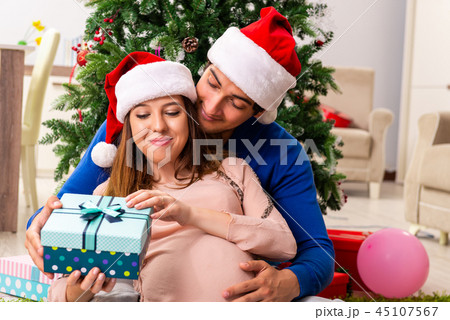 Pregnant wife celevrating christmas with husband 45107567