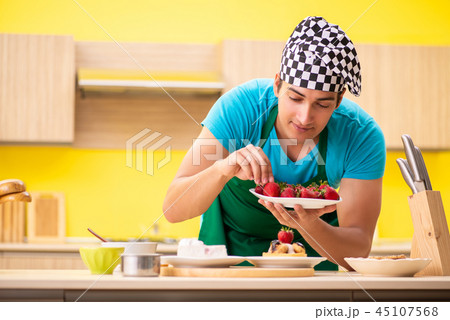 Man cook preparing cake in kitchen at home 45107568