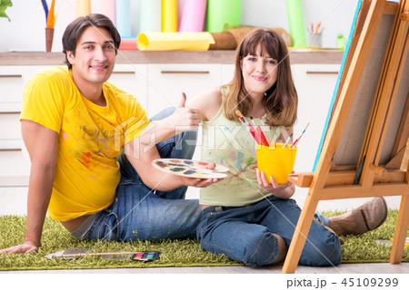 Young couple enjoying painting at home Young couple enjoying painting at home 45109299