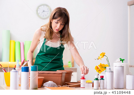 Young woman decorating pottery in workshop 45109448