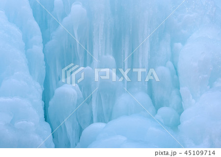 Texture of a frozen waterfall, background,  45109714