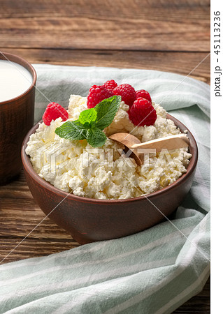 Cottage cheese with raspberries and wooden spoon 45113236