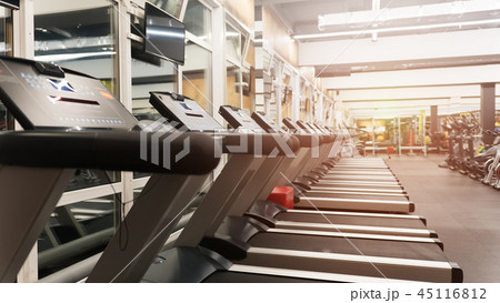 Row of treadmills in big new gym without people Row of treadmills in big new gym without people 45116812