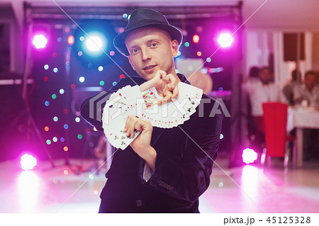 Magician showing trick with playing cards. Magic, circus Magician showing trick with playing cards. Magic, circus 45125328