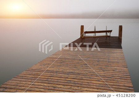 Empty footbridge with a bench on a lake Altausseer 45128200