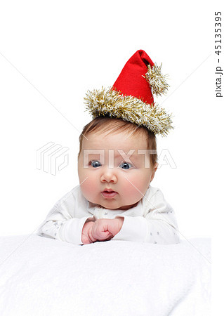 beautiful baby girl in christmas hat on white blanket beautiful baby girl in christmas hat on white blanket 45135395