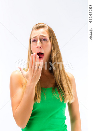 Sleepy young woman yawning Sleepy young woman yawning 45142208