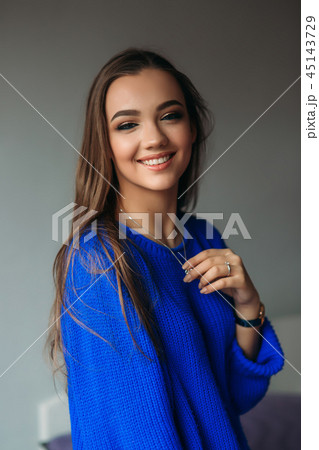 Young model with fashion makeup. Attractive girl in blue sweater 45143729