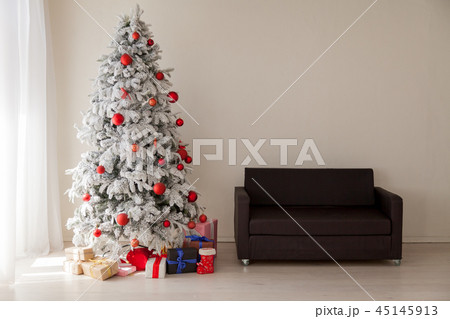 Christmas Decor Christmas tree with presents in a white room in winter 45145913