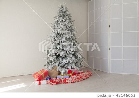 Christmas tree in a white room with gifts in the winter 45146053