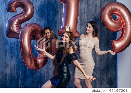 Group of females having fun. New year party. Young women celebrating. Christmas. 45147001
