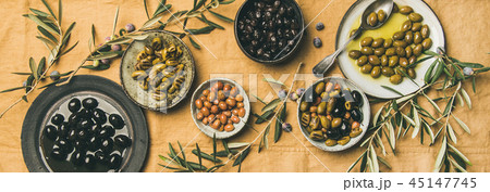 Flat-lay of mediterranean meze olives appetizers on yellow table cloth 45147745