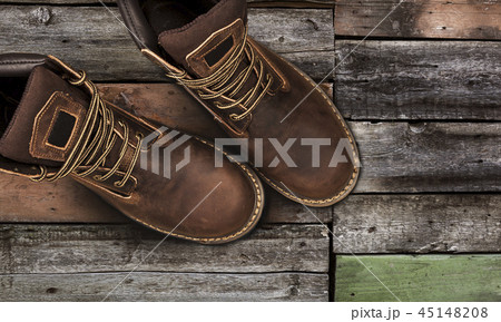 Brown men's boots, on a wooden background Brown men's boots, on a wooden background 45148208