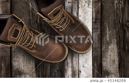 Brown men's boots, on a wooden background Brown men's boots, on a wooden background 45148209