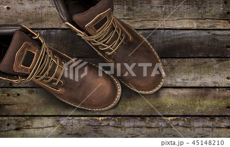 Brown men's boots, on a wooden background 45148210