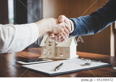 Real estate agent and customers shaking hands together celebrati 45149472