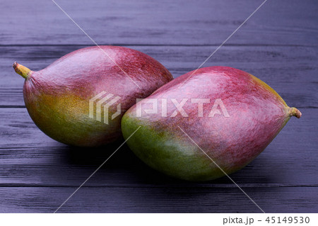 Fresh exotic mango on dark background. Fresh exotic mango on dark background. 45149530