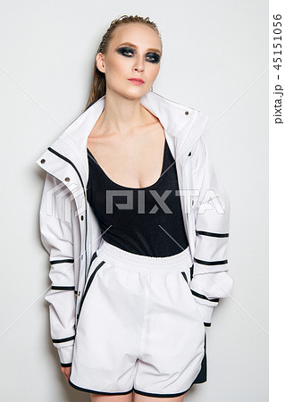 Fashion model in unzipped white sports suit. 45151056