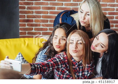 Four beautiful young woman doing selfie in a cafe, best friends girls together having fun, posing 45158917
