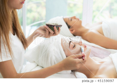 Beautiful woman having a facial treatment at spa. Beautiful woman having a facial treatment at spa. 45159097