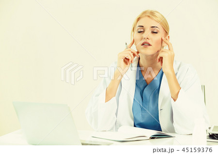 Doctor in hospital working on medical report. Doctor in hospital working on medical report. 45159376