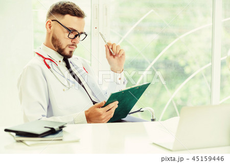 Doctor in the hospital with patient health file. Doctor in the hospital with patient health file. 45159446
