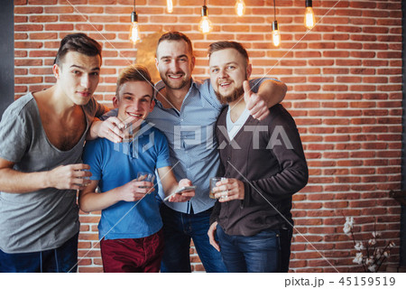 Cheerful old friends communicate with each other  glasses of whiskey in pub. Concept  entertainme 45159519