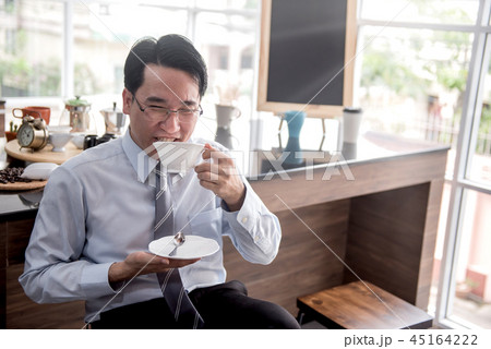 Businessman drinking hot coffee in the morning 45164222