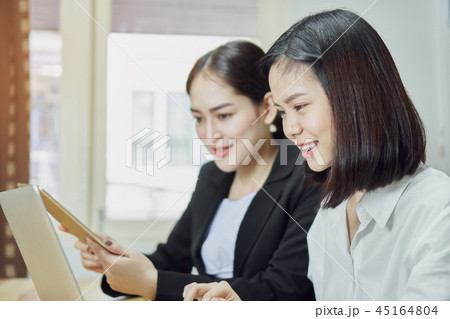 Business women are using laptops and smartphone. 45164804