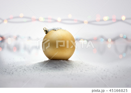 Yellow christmas ball on snow 45166825