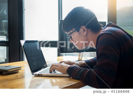Pensive programmer working on on desktop pc programming code tec Pensive programmer working on on desktop pc programming code tec 45166896