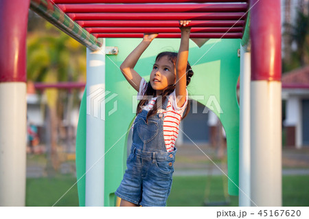 Cute asian child girl hang the bar by her hand Cute asian child girl hang the bar by her hand 45167620