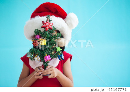 Cute asian child girl holding Christmas tree 45167771