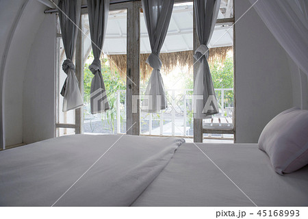 Interior of cottage with bed and curtain 45168993