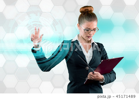 Young business lady works with virtual graphic interface in futuristic office Young business lady works with virtual graphic interface in futuristic office 45171489