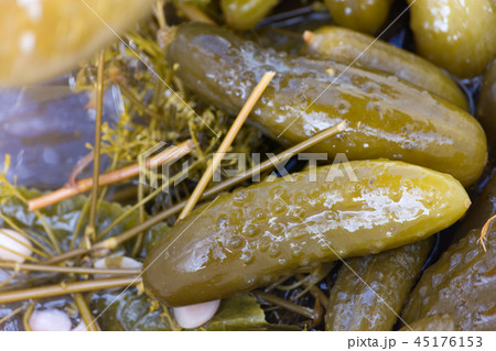 Pickled cucumber in marinade. Closeup. 45176153