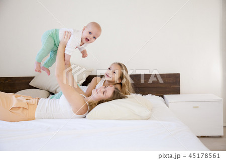 three girls sisters in the play in the bedroom in the morning love 45178561