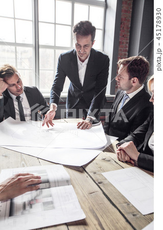 Business people with construction blueprint Business people with construction blueprint 45178930