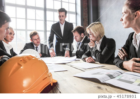 Business people with construction blueprint Business people with construction blueprint 45178931