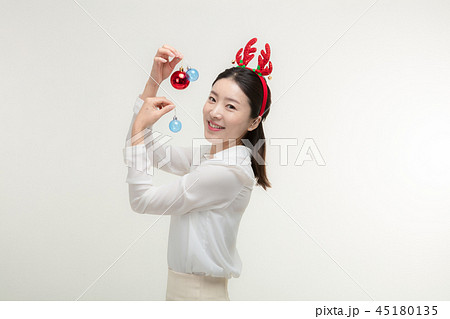 Christmas Day. Korea woman holding xmas props Christmas Day. Korea woman holding xmas props 45180135