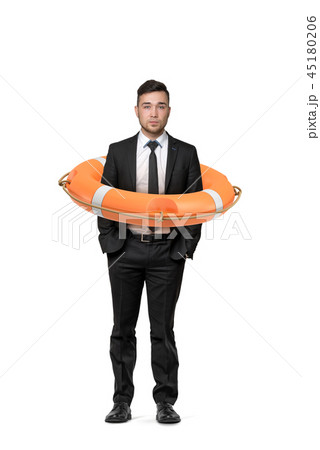 A young businessman stands on a white background while inside an orange life buoy. A young businessman stands on a white background while inside an orange life buoy. 45180206